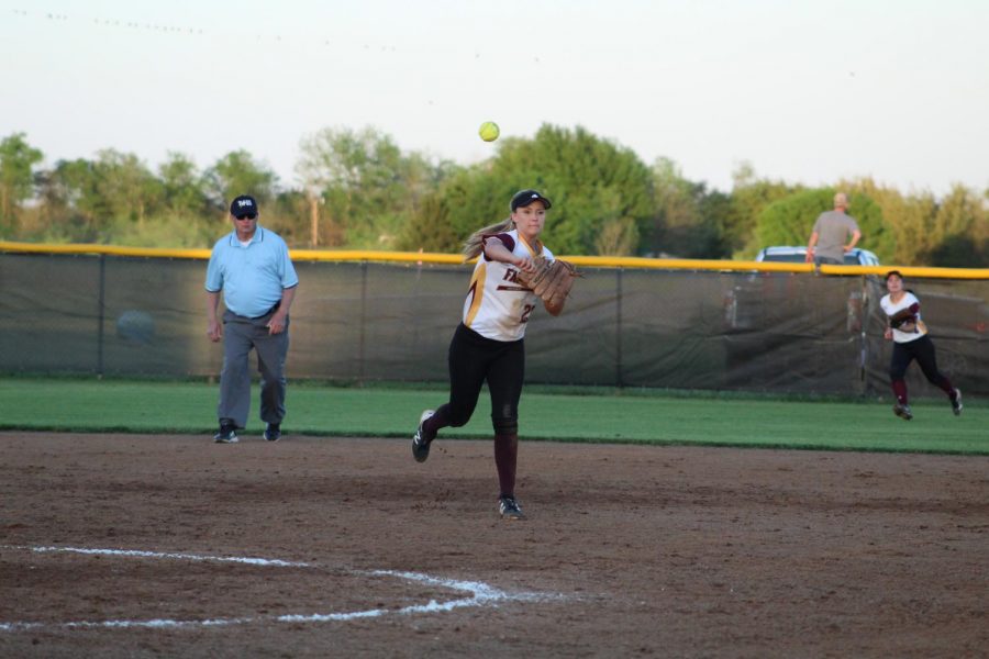 Caption: Senior Lauran Adcock throws the ball to first in the last district game, helping her team defeat Mexia and win district.