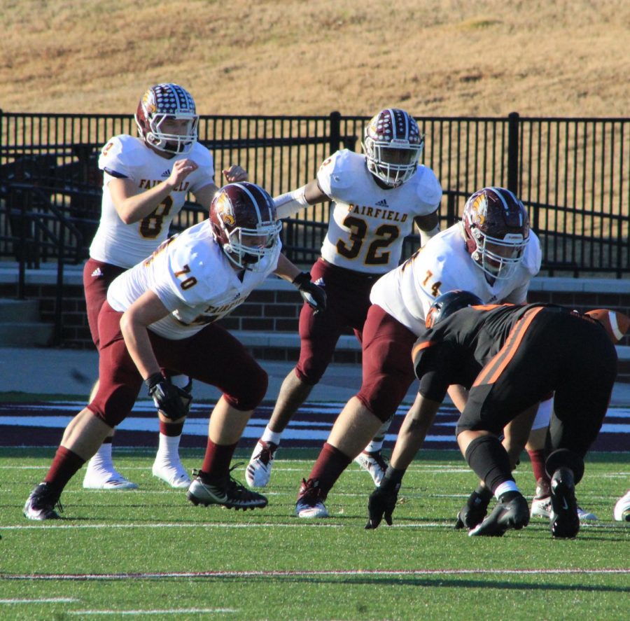 #8 Chad Rushin, #70 Klay Bonner, #32 Jashaughn Hatcher, and #74 Josh Arrington prepare for the snap against Gilmer. Photo by Melanie Pina. 