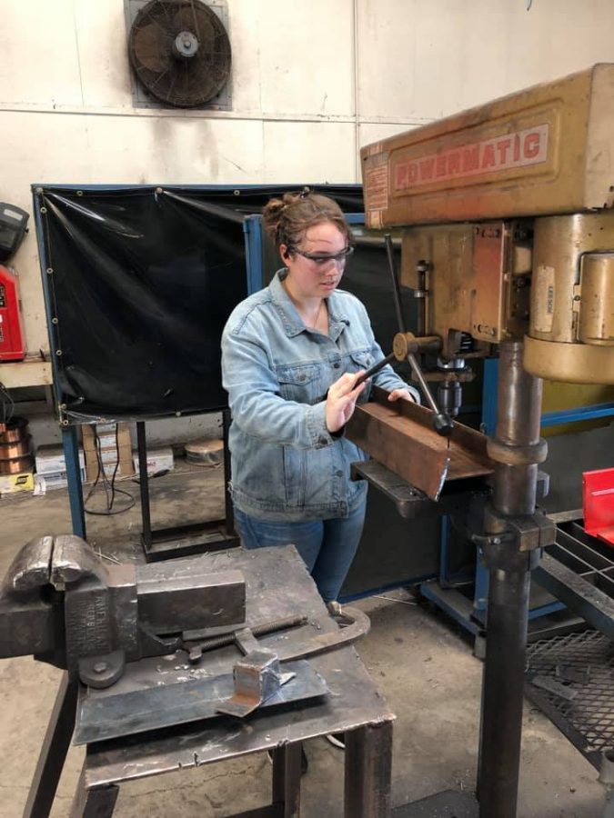 Junior Madison Thaler uses  a machine to help build the trailer. Photo contributed by Fairfield FFA Chapter