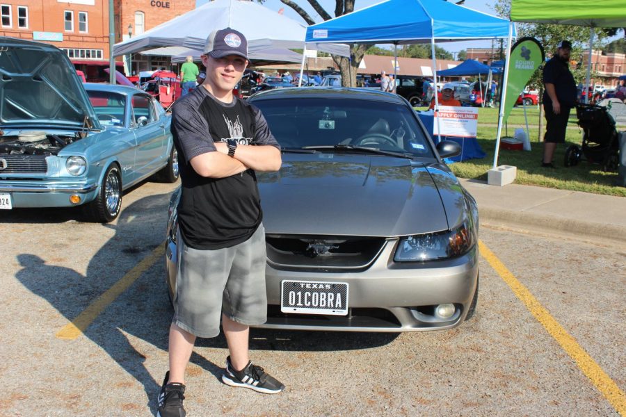 Senior Kaleb Shoemaker stands next to his 01 Cobra. Photo by Isabel Growden.