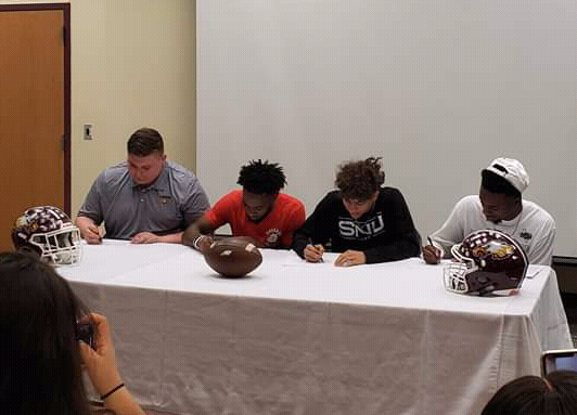 Seniors Chandler Noble, JarMycheal Hudson, DeQuann McWilliams, and Justin Abram sign to their schools. Photo contributed by FISD.