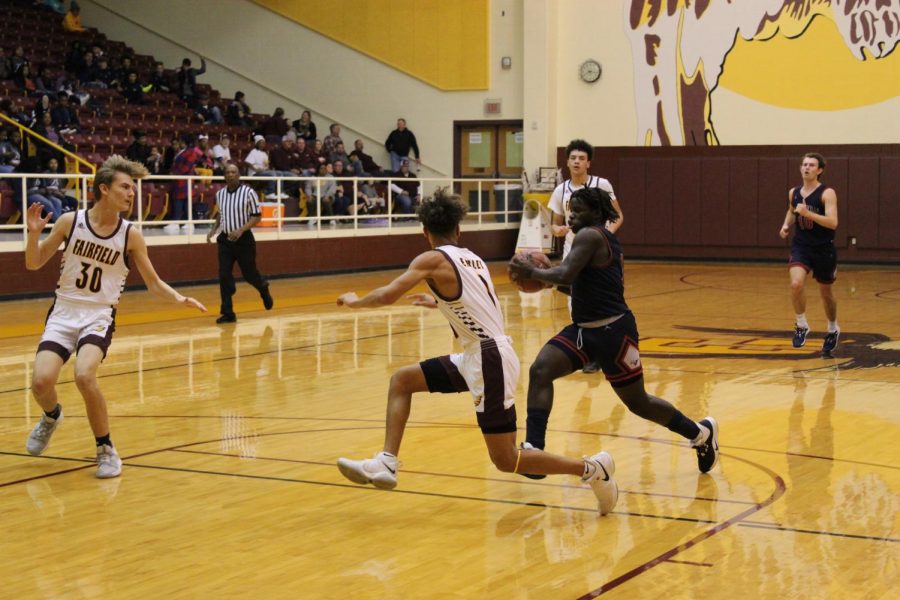 Senior DeQuann McWilliams  guards opponent from Madisonville. Photo by Hailey Lane.