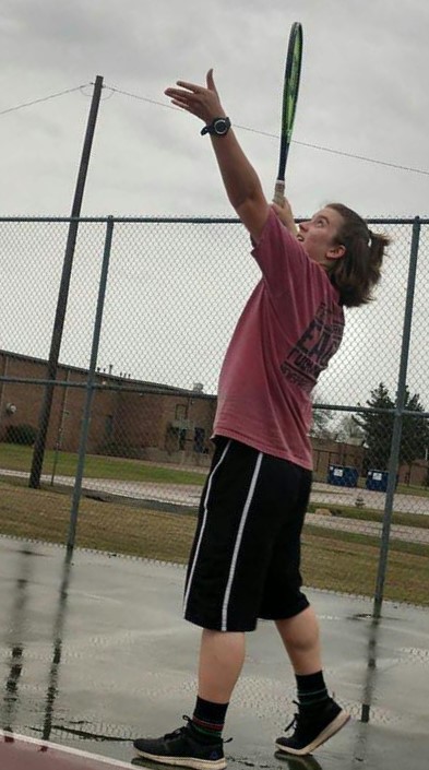 Senior Merrianne Markham practices her serve. Photo contributed by Carl Markham.