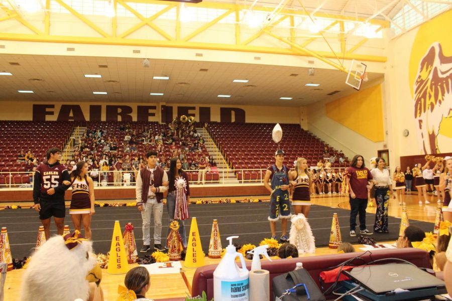 The senior Homecoming queen nominees and their escorts are introduced at the pep rally.