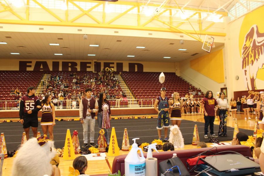 The+senior+Homecoming+queen+nominees+and+their+escorts+are+introduced+at+the+pep+rally.