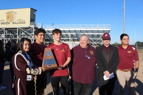 Band Director Russell Holland receives the advancing award for UIL district marching. The Grand Band will compete in area on October 23 at Robinson High School. Pictured with Holland are senior Yadira Yepez, senior Nicolas Martinez, senior Mason Wright, assistant band director Gust Witt, Holland, assistant band director Adan Coronado.