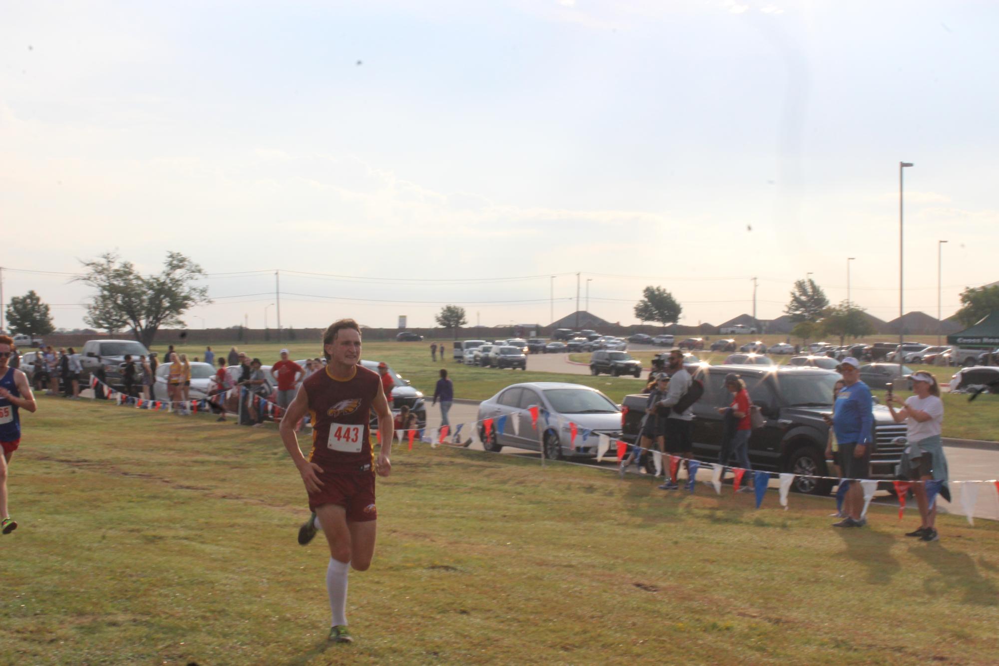 Junior Jerry Draper, 2022 cross country state competitor, finishes the course at the Ennis meet.